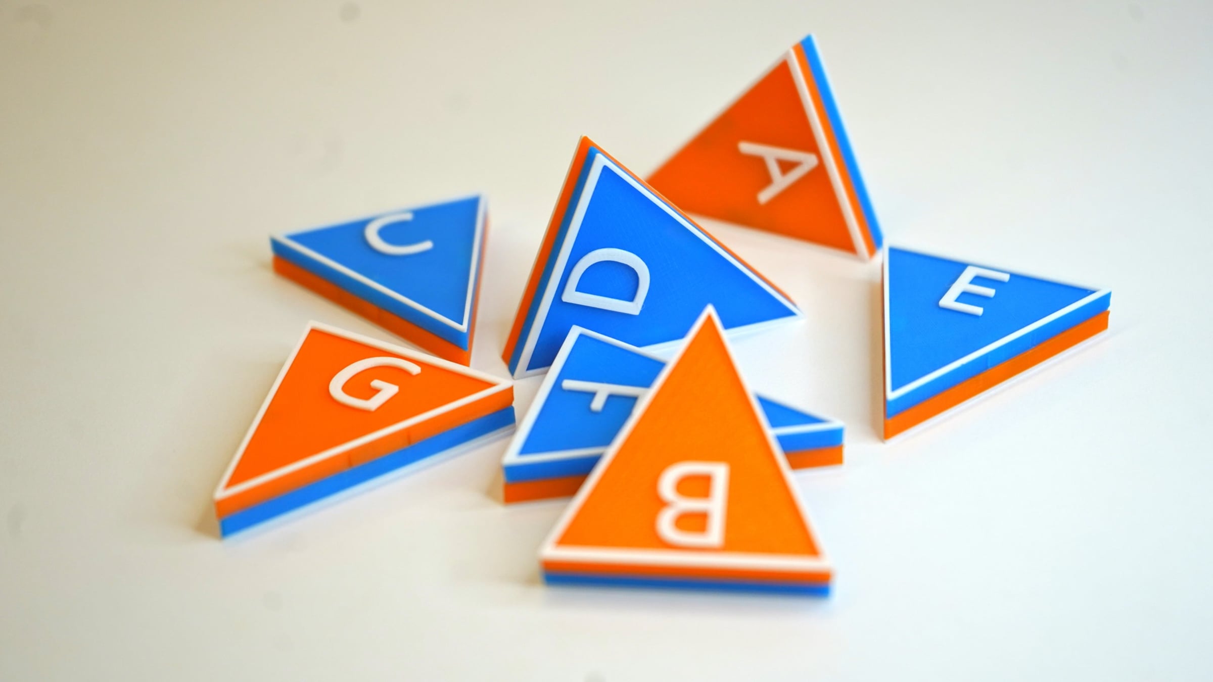 blue and orange triangular tiles with music letter names on them