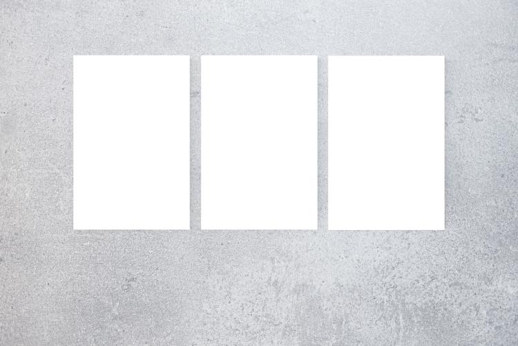 three blank posters on a wall