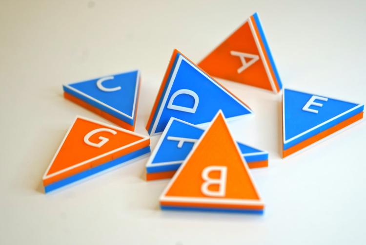 blue and orange triangular tiles with music letter names on them