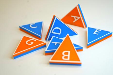 blue and orange triangular tiles with music letter names on them