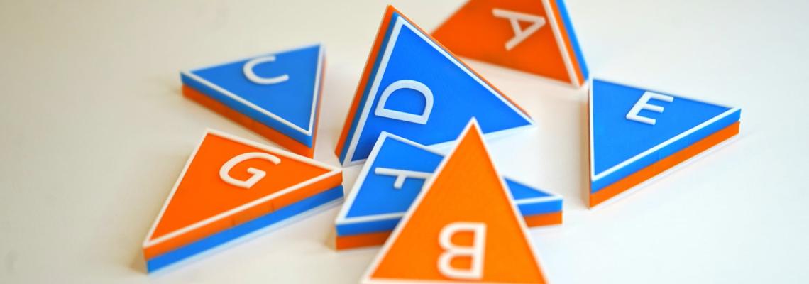 blue and orange triangular tiles with music letter names on them
